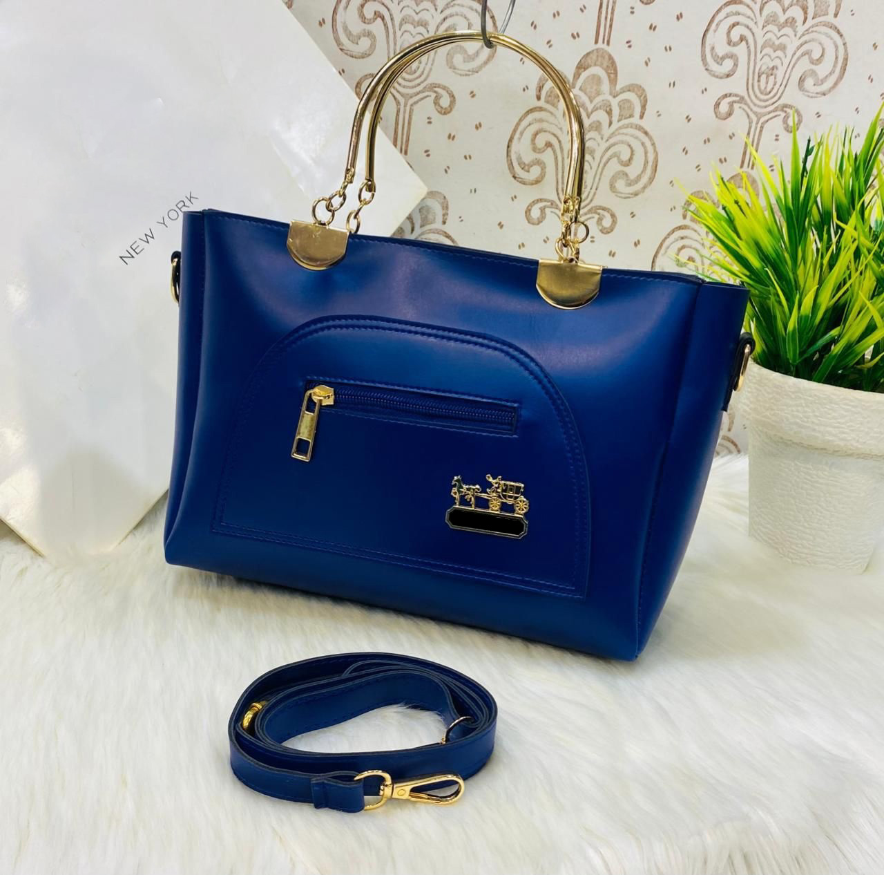 Stylish Blue Handbag with Gold Accents & Detachable Strap