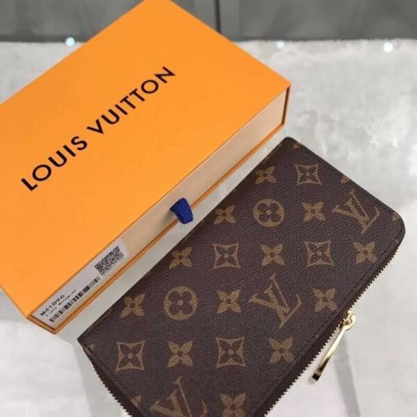 Louis Vuitton Brown Monogram Wallet held in hand with classic logo design