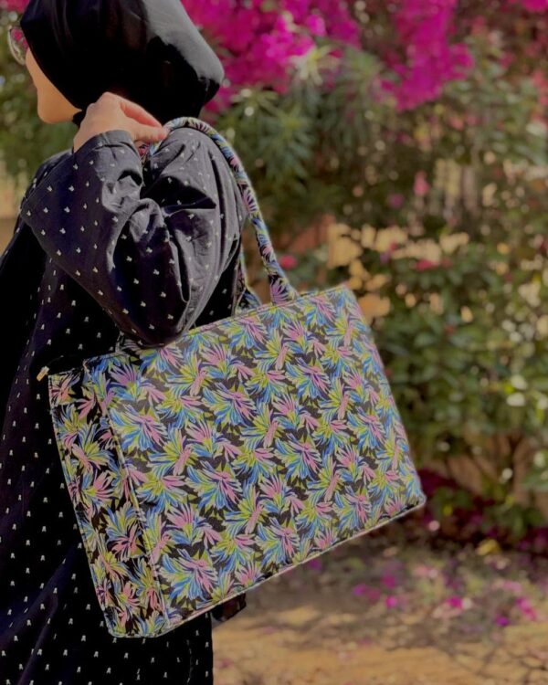 Women's floral structured tote bag with pink, green, and blue leaf pattern