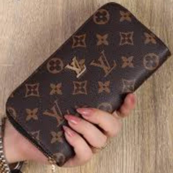 Louis Vuitton Brown Monogram Wallet held in hand with classic logo design