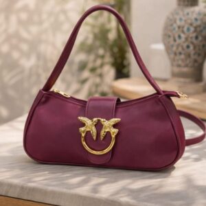 Zwore mahroon handbag close-up showing bird buckle detail